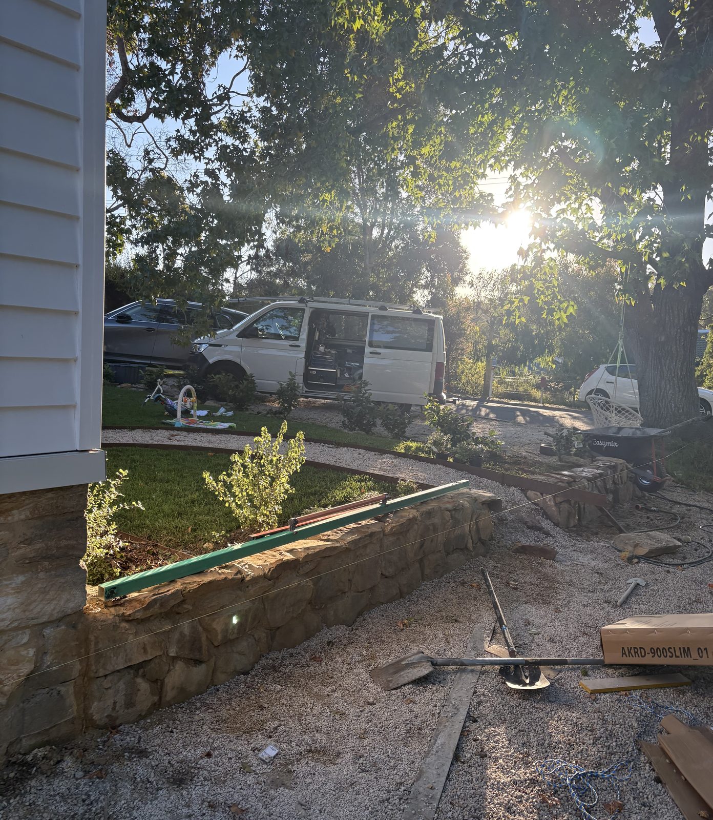 A stone retaining wall under construction in the front garden
